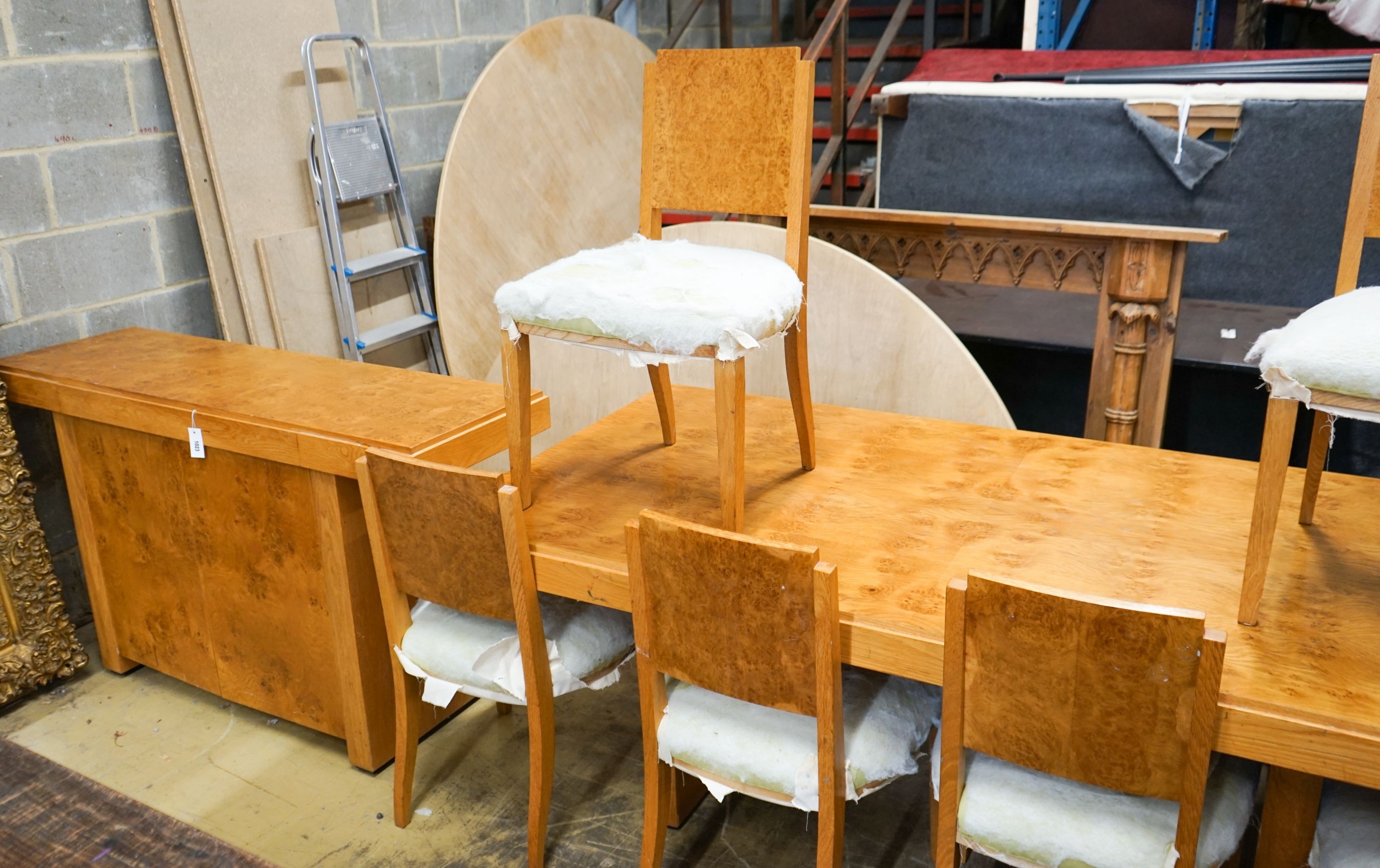 An Art Deco style bird's eye maple dining suite comprising table, six chairs and side cabinet, table length 200cm, width 104cm, height 72cm